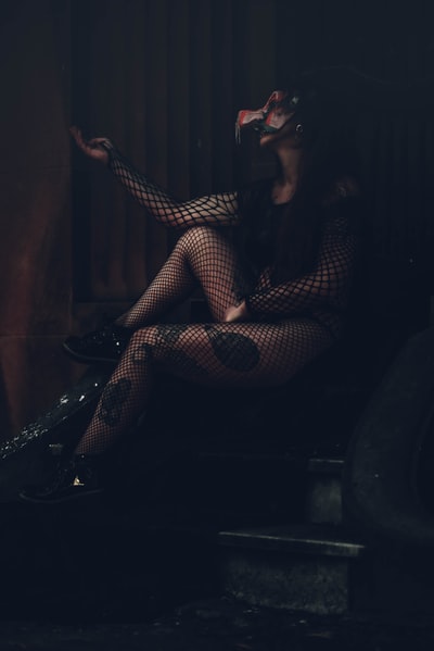 穿着黑白格子裙坐在黑色椅子上的女人